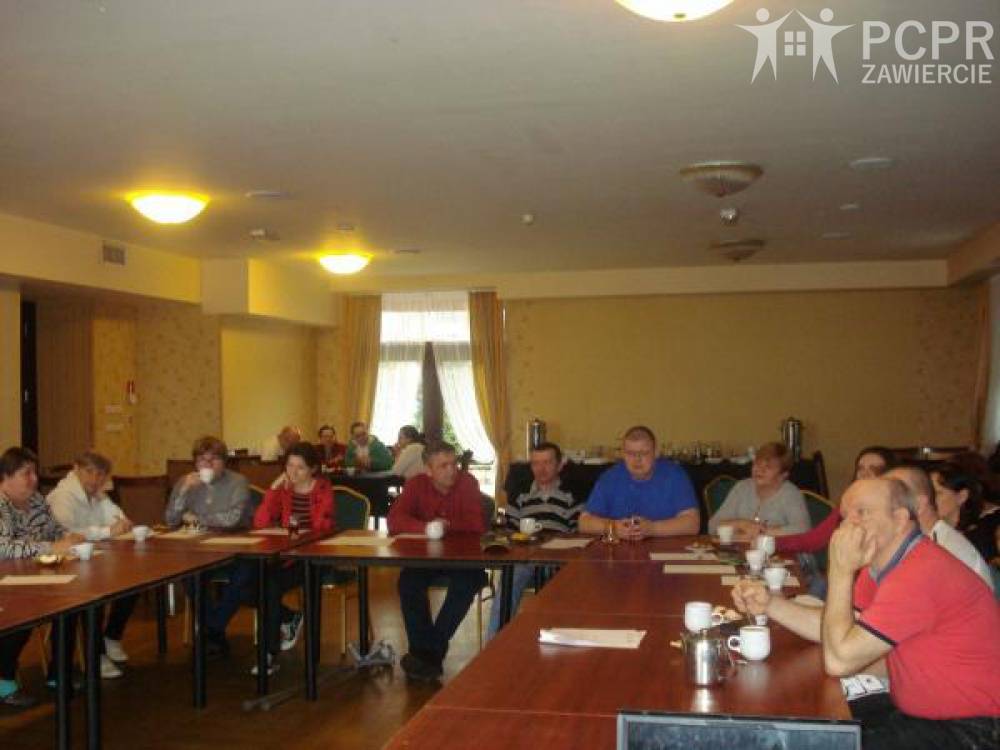 Zdjęcie: Kobiety i mężczyźni siedząc przy stole uczestniczą w warsztatach
